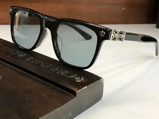 A pair of black-framed sunglasses resting on a wooden surface