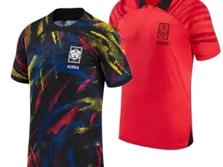 Two football shirts, one black with a multicoloured print and one red