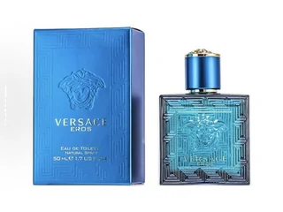 A blue glass fragrance bottle beside its blue carton